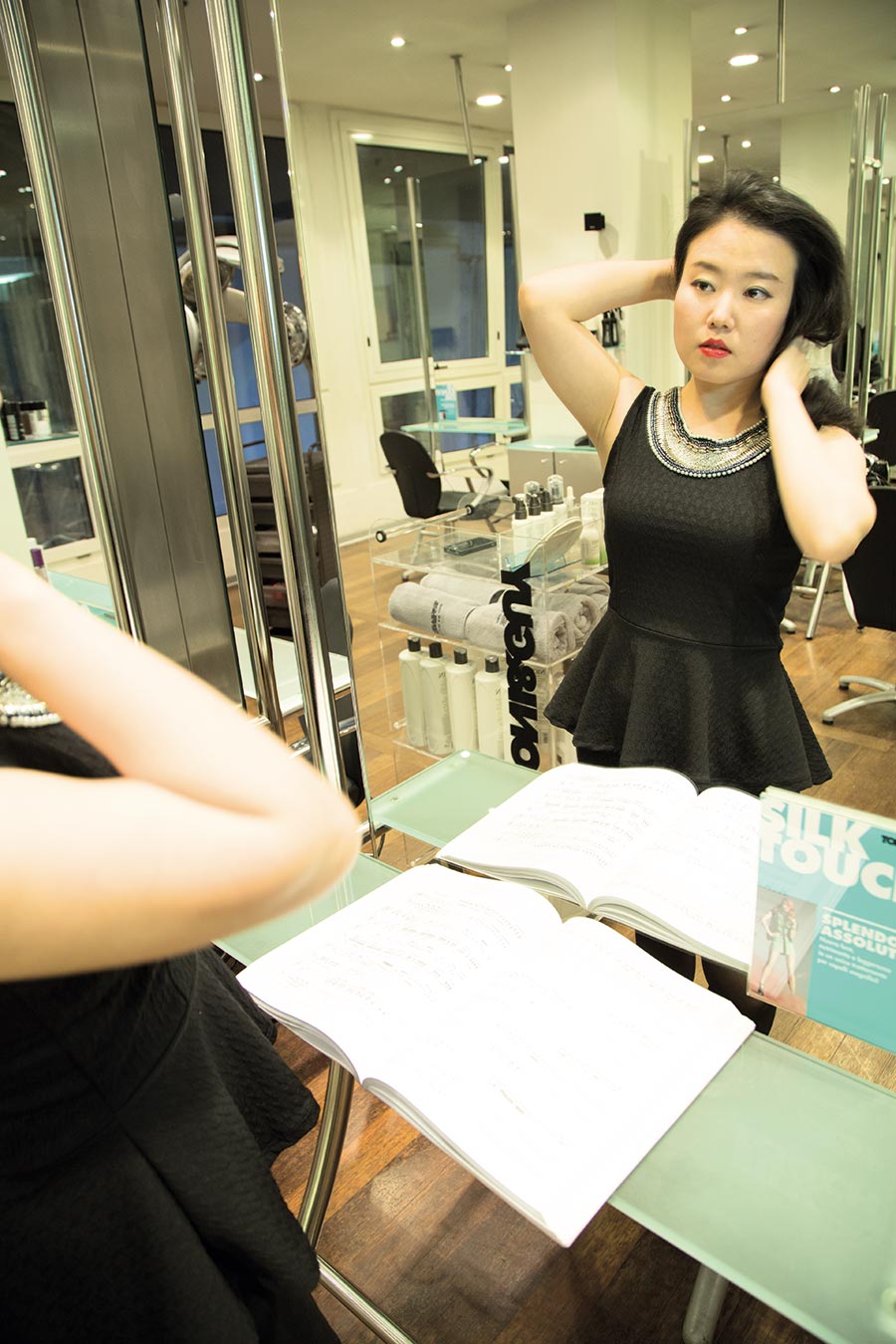 Jiyeong Son is posing in front of the mirror at the Tony&Guy hair salon, in Milan. Photos by Max Di Vincenzo, Milan, Italy